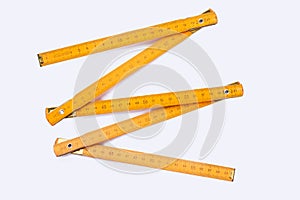 Yellow wooden ruler isolated on white background.