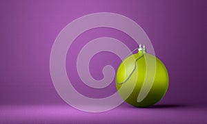 Yellowish-green Christmas ball on violet background