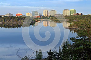 Yellowknife Skyline reflected in the Still Waters of Frame Lake in Evening Light, Northwest Territories, Canada