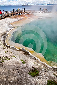 Yellowstone, Wyoming, USA, May 25, 2021: Black Pool in West Thumb Geyser Basin with tourists
