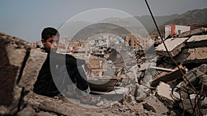 Yemeni children on the rubble of destroyed homes