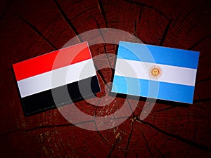 Yemeni flag with Argentinian flag on a tree stump