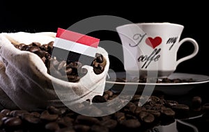 Yemeni flag in a bag with coffee beans on black