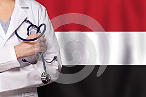 Yemeni medicine and healthcare concept. Doctor close up against flag of Yemen background