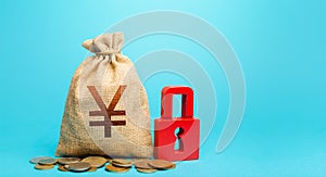 Yen Yuan money bag and red padlock. Blocking bank accounts and seizing assets. Tight government control over the financial system