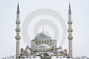 Yeni Mosque in snowfall photo