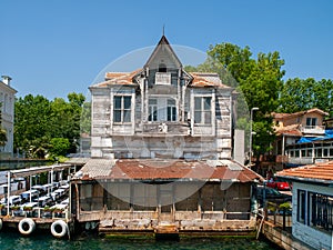 Yenikoy, Istanbul / Turkey -  Abandoned  old wooden mansion at Bosporus coast and restaurant yard beside it
