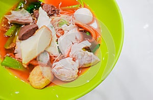 Yentafo noodles contain moning glory,squid,meat ball,fish ball and pink soup put on the table, Thailand Street Food