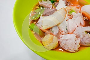 Yentafo noodles contain moning glory,squid,meat ball,fish ball and pink soup put on the table, Thailand Street Food photo