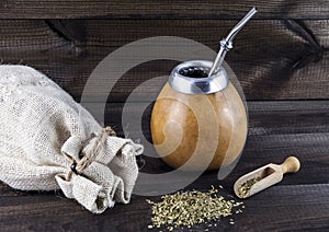 Yerba mate with equipment on wooden table