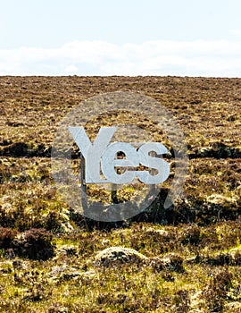 Yes in big white wooden letters with Scottish moorland in the background