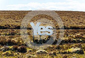 Yes in big white wooden letters with Scottish moorland in the background