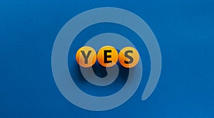 Yes choice symbol. Orange table tennis balls with the word `yes`. Beautiful blue background. Business, choice and yes concept,