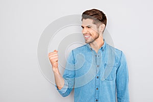 Yes! Happy successful young businessman showing fist