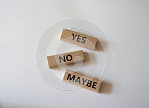 Yes No Maybe symbol. Concept word Yes No Maybe on wooden blocks. Beautiful white background. Business and Yes No Maybe concept.