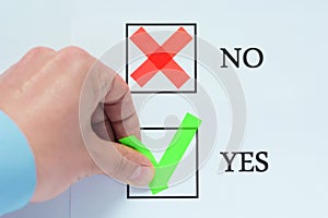 Yes No tickbox with green red tick. Hand holding mark