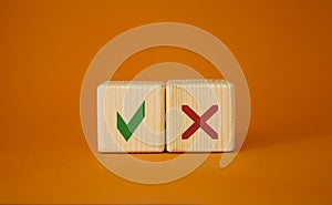 Yes vs No symbol. Wooden cubes with words YES and No. Beautiful orange background. Business concept. Copy space