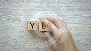 Yes, woman making word of cubes, success and achieving goals, bright future