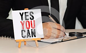 YES YOU CAN. Woman holding blackboard in hands with text YES YOU CAN