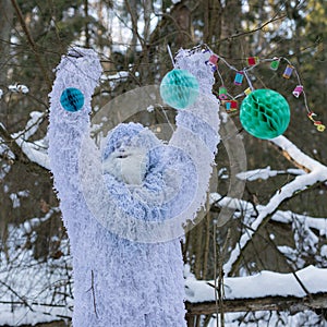 Yeti fairy tale character in winter forest. Outdoor fantasy photo.