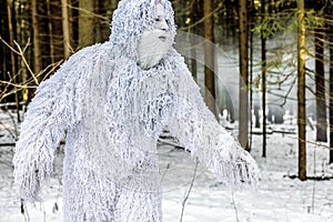 Yeti fairy tale character in winter forest. Outdoor fantasy photo.