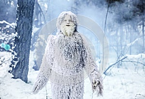 Yeti fairy tale character in winter forest. Outdoor fantasy photo.