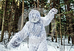 Yeti fairy tale character in winter forest. Outdoor fantasy photo.