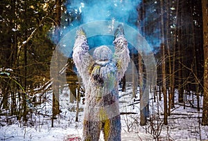 Yeti fairy tale character in winter forest. Outdoor fantasy photo.