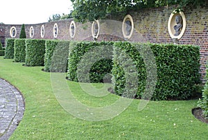 Yew topiary garden with statues in alcoves photo
