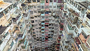 Yick Cheong and Yick Fat old apartment house exterior architecture in Hong Kong city, drone aerial view