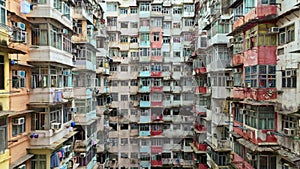 Yick Cheong and Yick Fat old apartment house exterior architecture in Hong Kong city, drone aerial view