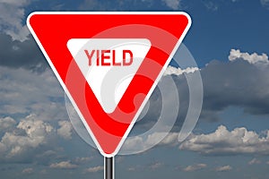 Yield Sign with clouds photo