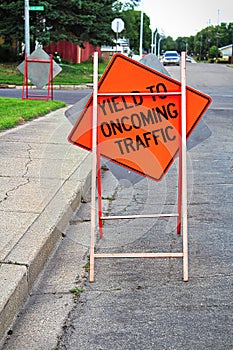 Yield to oncoming traffic construction sign on the road