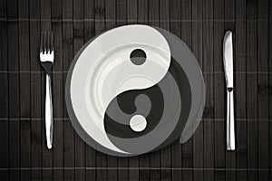 Yin yan plate over bamboo placemat concept