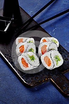 Yin and yang shaped futomaki rolls with salmon and cucumber