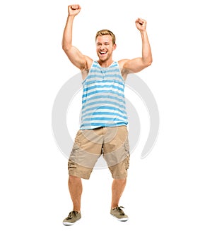 Yipee. Full length shot of a handsome young man standing alone in the studio with his arms raised in celebration.