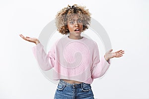 Yo watch your mouth. Portrait of insulted pissed african-american woman with blond haircut raising hands sideways in