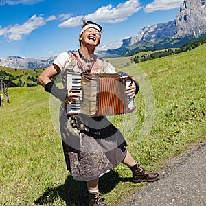 Yodeling in Alps - musician singing and playing accordion