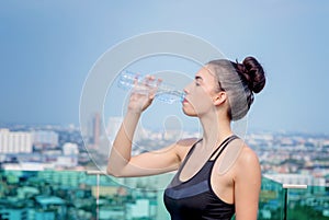 Yoga athlete woman drinking water after work out