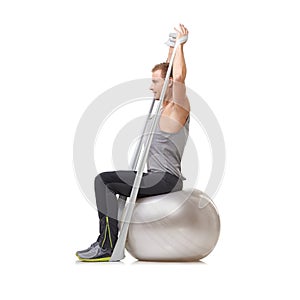 Yoga ball, resistance band and man doing exercise in studio for health, wellness and bodycare. Sport, fitness and young