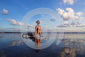 Yoga on the beach at sunset