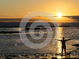 Yoga at the beach at sunset.