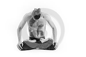 Yoga. Black and white Portrait of yogi men doing yoga exercise, he breath and performing Upward abdominal lock. Young men workout