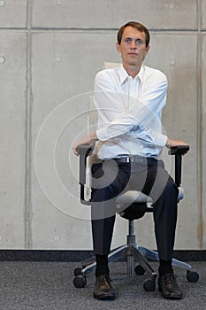 Yoga on chair in office - business man exercising