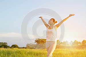 Yoga in the city: beautiful young fit woman wearing sportswear meditating, breathing, sitting with crossed legs in Half Lotus