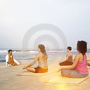 Yoga Class By The Beach Having Breathing Excercise Concept
