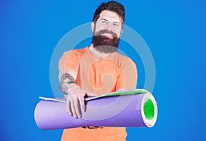 Yoga class concept. Yoga as hobby and sport. Practicing yoga every day. Man bearded athlete hold fitness mat. Fitness