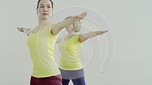 Yoga class doing cobra pose together on exercise mats at the gym