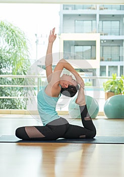 yoga class studio,asian woman master doing One Legged King Pigeon pose,Healthly lifestyle sport