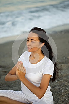 Yoga concept. Female practicing yoga at the beach.